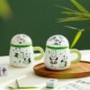 Cute panda ceramic cup with lid, ideal for coffee and water.