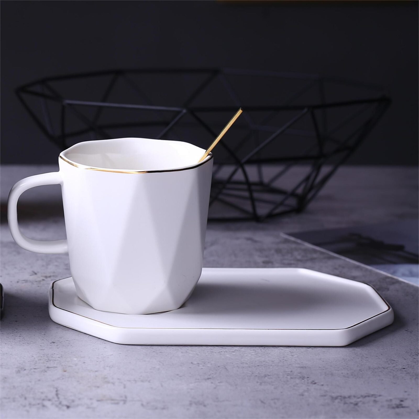 Geometric ceramic tea set with gilded accents.