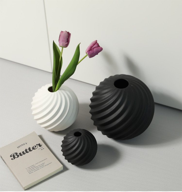 Modern ceramic round vase in black and white for home décor.
