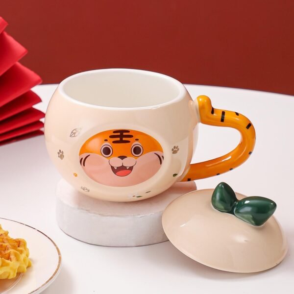 Ceramic coffee mug with a cartoon tiger design and matching lid.