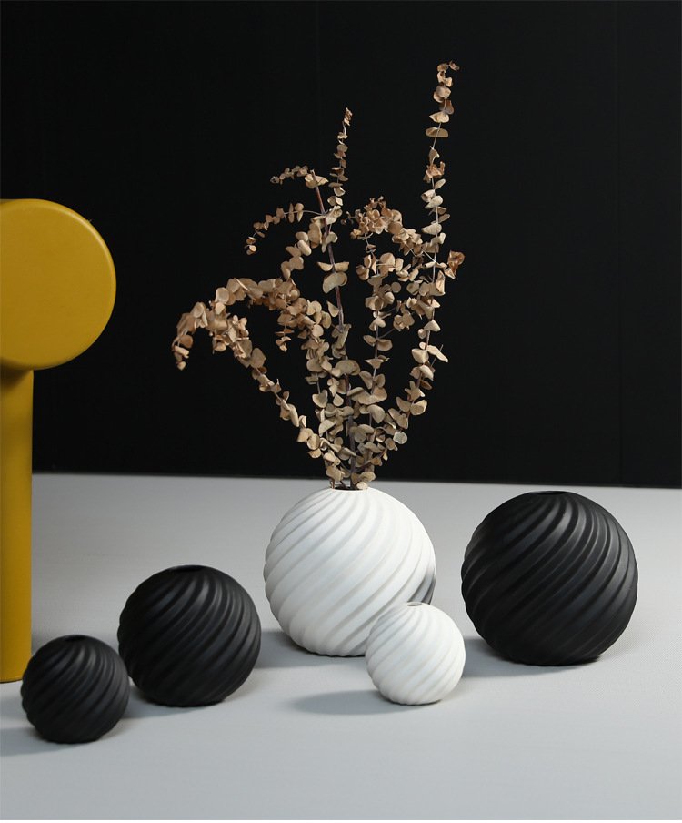 A minimalist ceramic vase in black and white, ideal for modern home and office décor.