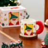 Festive ceramic coffee cup with Santa and gift designs